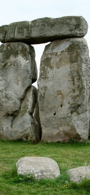 Ancient stone structure of Stonehenge standing on green grass