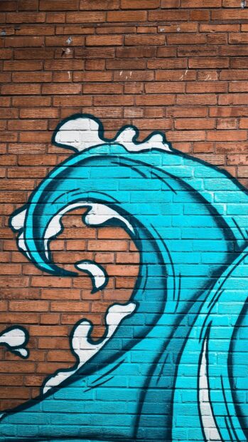 Blue wave street art painted on brick wall showing artistic urban design