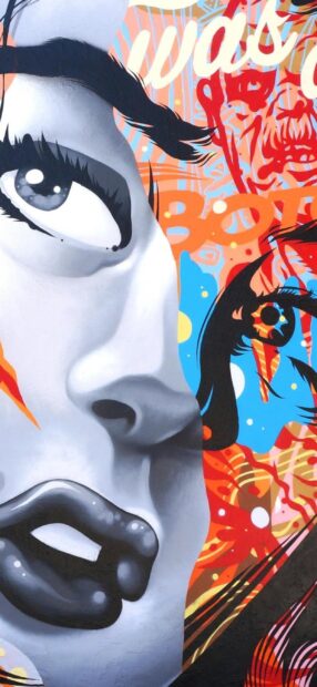 Close up of street art featuring vibrant facial expressions and colors