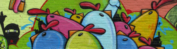 Colorful street art featuring cartoon birds on a brick wall wallpaint