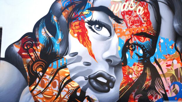 Colorful street art portrait of a woman with abstract patterns and expressive eyes