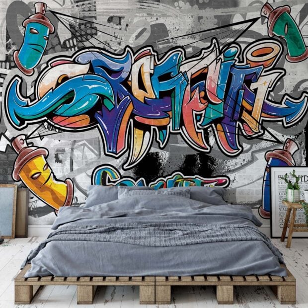 Colorful street art graffiti with spray cans on urban wall behind bed
