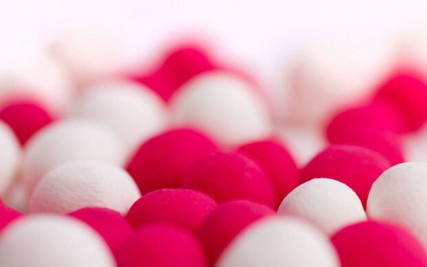 Close up of sweets in vibrant red and white colors arranged in a pattern