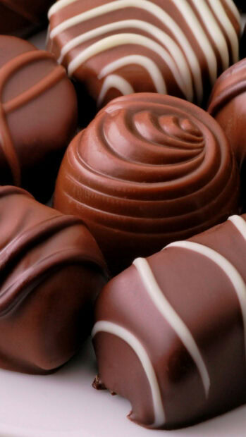Close up of delicious assorted sweets with creamy chocolate swirl patterns