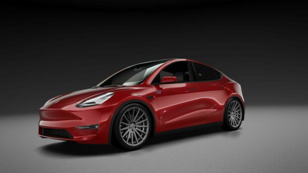 Red Tesla Model Y with sleek design and sporty wheels on a gray surface