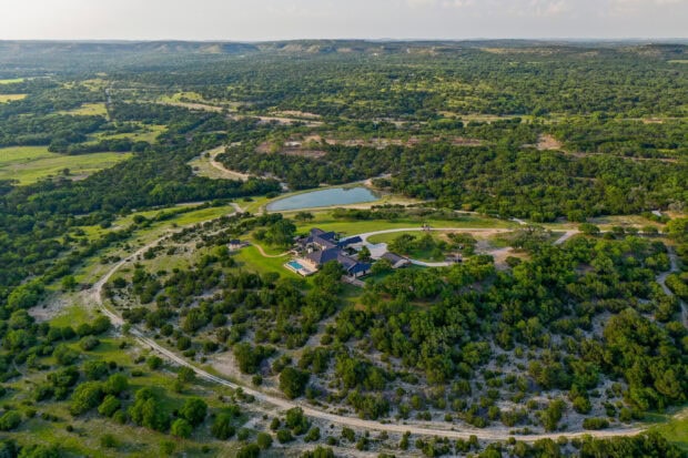 Aerial view of Texas Hill Country ranch surrounded by lush greenery and natural landscape
