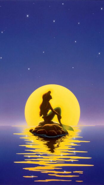 The Little Mermaid silhouette sitting on a rock with a large glowing moon behind her