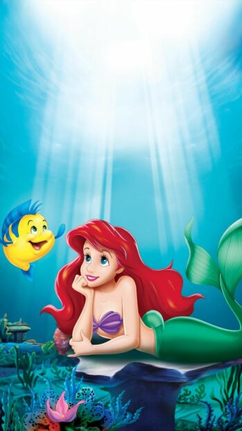 Ariel the little mermaid relaxing underwater with a friendly fish companion