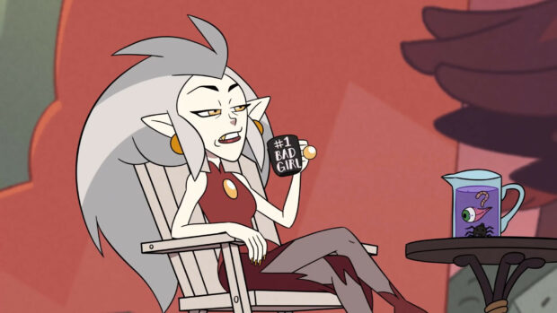 A character from The Owl House holding a cup with the phrase bad girl sitting on a chair