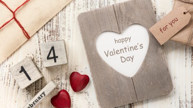 Wooden calendar blocks showing February 14th with Valentine decor and love hearts