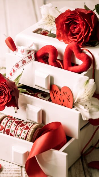 Red and white Valentine decorations with roses and heart shapes in white drawers displaying romantic elements