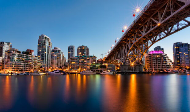 Evening cityscape with Vancouver Canada skyline and waterfront reflecting lights