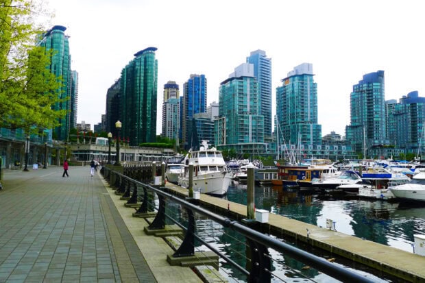 Vancouver cityscape with modern buildings and boats along the waterfront in Canada