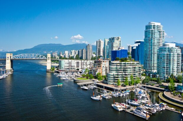 Modern buildings and marina in downtown Vancouver Canada with a clear blue sky