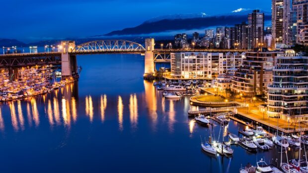 Night view of Vancouver Canada cityscape with bridge and waterfront marina