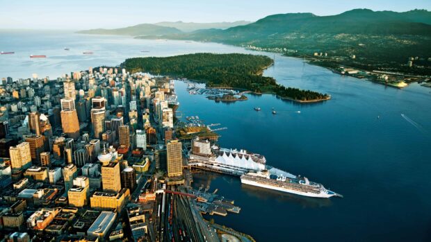 Aerial view of Vancouver Canada cityscape with Stanley Park and cruise ships docked at the harbor