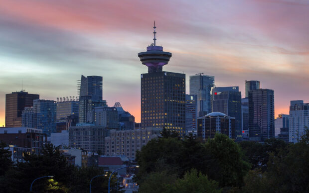 Vancouver Canada city skyline at sunset with high rise buildings and a colorful sky