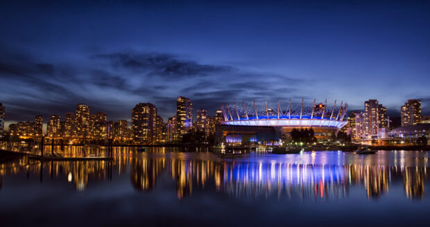 Vancouver city skyline with BC Place illuminated at night in Canada