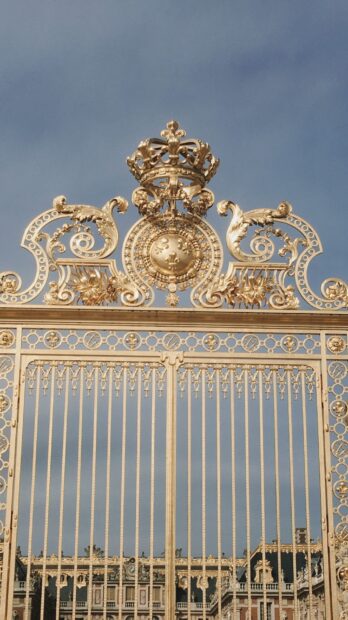 Golden gate decoration with crown emblem at Versailles palace