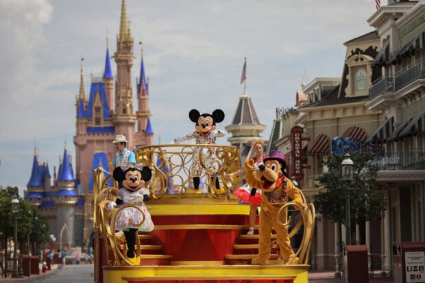 Mickey Mouse and friends performing at Walt Disney World Resort with Cinderella Castle in the background
