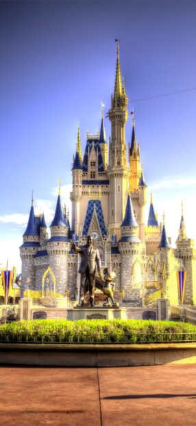 The statue of Walt Disney and Mickey Mouse stands in front of the Cinderella Castle at Walt Disney World Resort