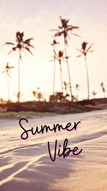 Summer sand with palm trees in the background and summer vibe text on the beach