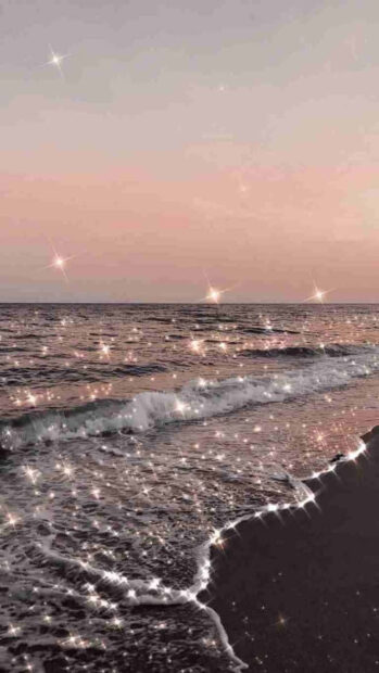 A serene ocean wave glistening with sparkles under a soft summer sky