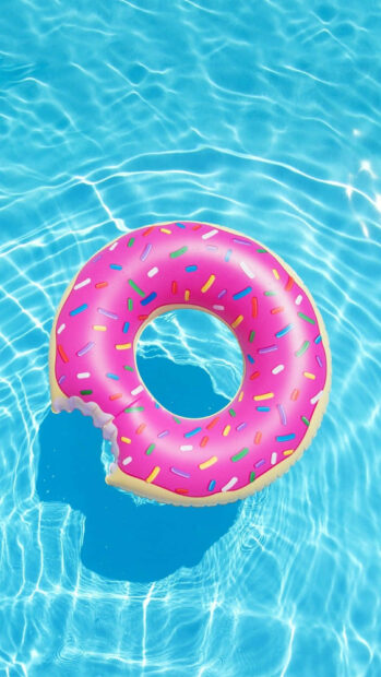 Pink donut shaped float with colorful sprinkles in a clear blue pool water