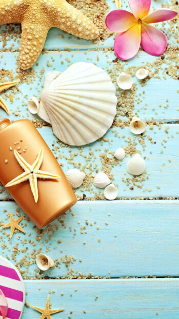 Summer elements with starfish shells and a flower on blue wooden boards