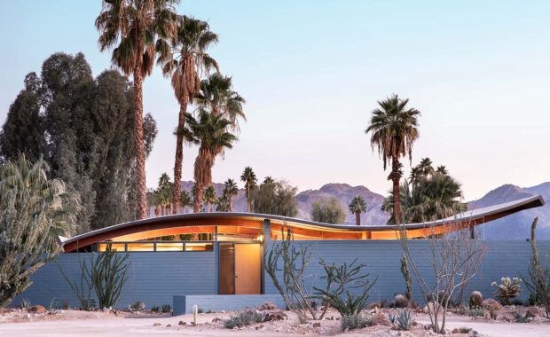 Modern desert house with palm trees in Palm Springs desert landscape