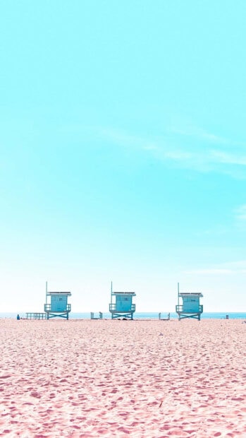 Pastel summer scene with lifeguard towers on soft sandy beach