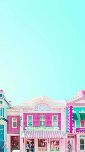 A pastel summer scene of a candy palace with pink and turquoise architecture under a bright blue sky