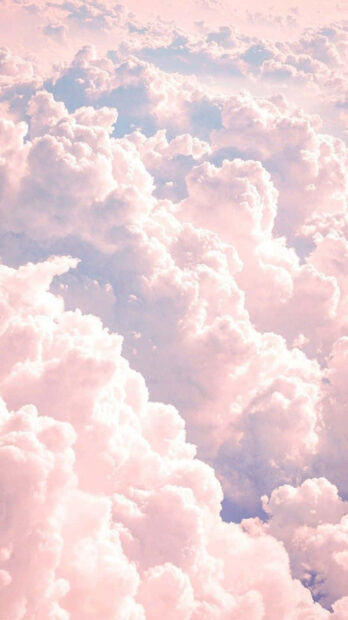 Soft pastel summer clouds floating in the sky with gentle pink hues