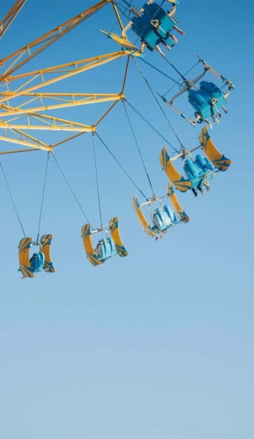 Vintage amusement ride with pastel colors in a clear summer sky