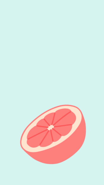 A pink summer grapefruit cut in half on a light blue background
