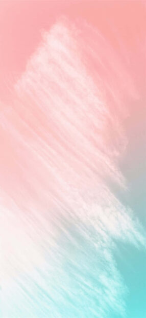 Soft pink summer colors blend with light blue clouds in a calm sky