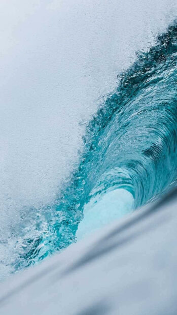 A dynamic close up of ocean wave curl showcasing vibrant blue tones and motion