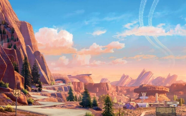 A scenic view of Radiator Springs with rock formations and Route 66 sign under a vibrant sky