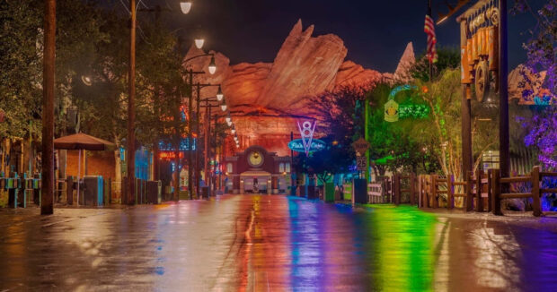 Radiator Springs at night with colorful reflections on the wet street and neon lights