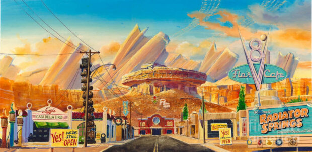 Radiator Springs town scene with mountains and sign visible on a clear sunny day