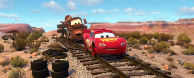 Lightning McQueen and Mater on railroad tracks in Radiator Springs landscape