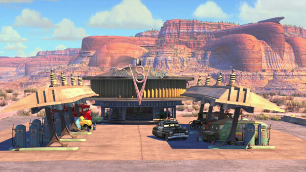 Radiator Springs features a historic gas station surrounded by animated vintage vehicles in a desert landscape