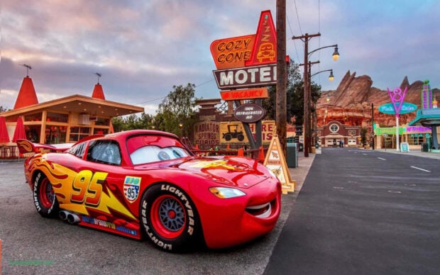 Radiator Springs race car character Lightning McQueen parked near Cozy Cone Motel in Radiator Springs