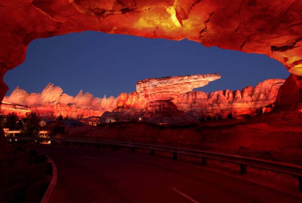 Radiator Springs rock formations glowing at dusk in a scenic desert landscape