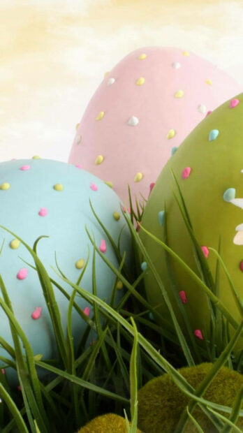 Colorful pastel Easter eggs nestled in fresh grass for spring aesthetic