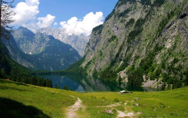 Green mountain landscape with lake and clear spring sky in mountain valley