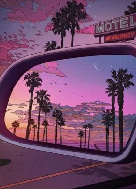 Palm trees during a summer sunset seen through a car side mirror