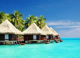 Tropical huts over ocean on summer vacation