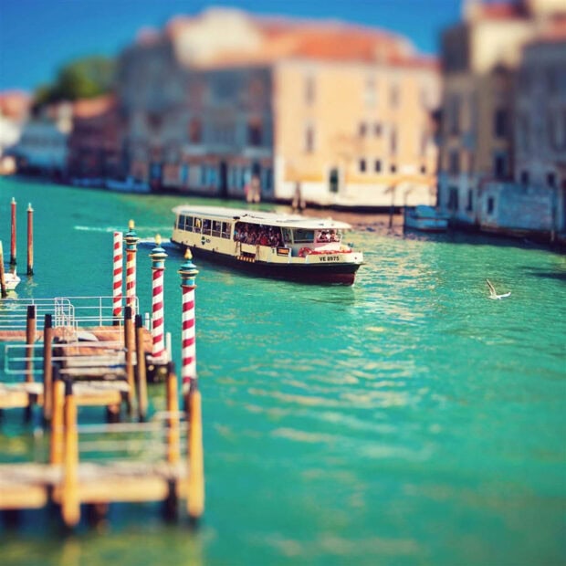 Summer boat cruising on a sunny summer waterway in a vibrant city