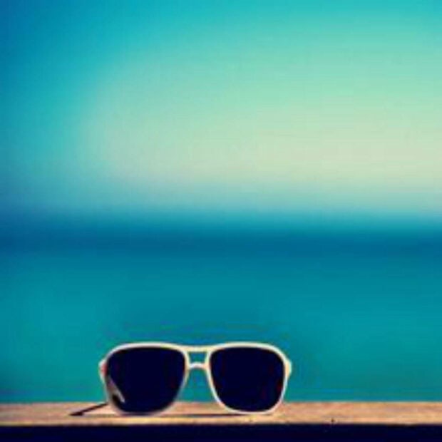 Sunglasses resting on a ledge during summer